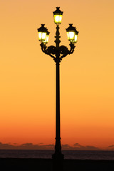 street lantern against the orange sunset sky