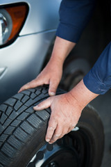 mechanic changing a wheel of a modern car