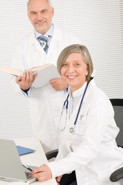 Medical team doctors by desk work computer