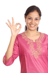 Woman showing OK sign against a white background