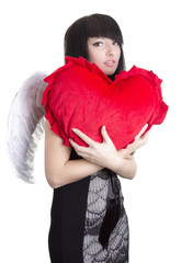 Beautiful angel woman embracing red heart