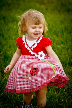 Girl Smiling in Grass Field