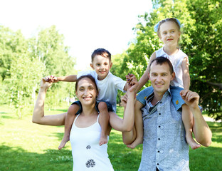 Family with two children in the summer park