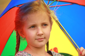 portrait of little girl with a smile and an umbrella