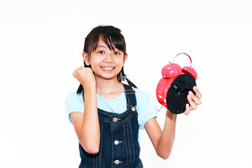 Fototapeta premium 目ざまし時計を持ちガッツポーズをしている女の子