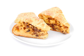Mushroom pie on plate on white background