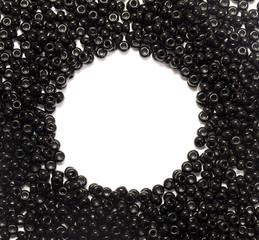 black pearls scattered on a white background with place for text