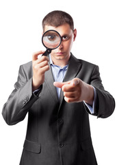 businessman in a suit looking through a magnifying glass isolate