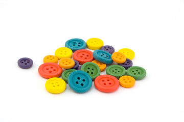 Pile of colorful buttons over white