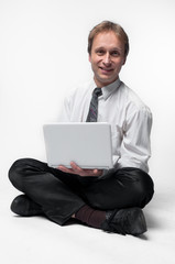 Young businessman yoga before an open notebook