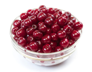 Bowl with ripe cherries. Isolated on a white background.