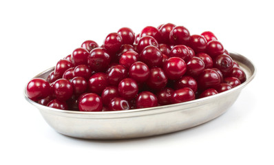 Bowl with ripe cherries. Isolated on a white background.