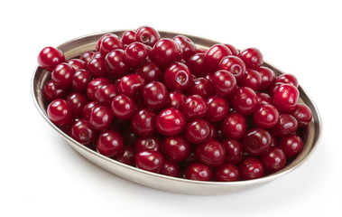Bowl with ripe cherries. Isolated on a white background.