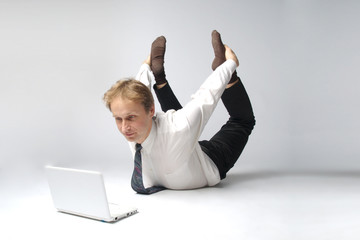 Young businessman yoga before an open notebook