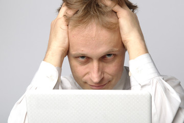 Portrait of middle-aged man with a white laptop computer