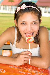 Portrait of beautiful girl with lollipop ..