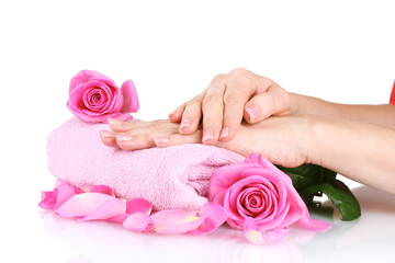 Pink towel with roses and hands on white background