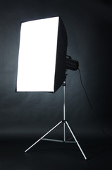 Studio flash with soft-box  on black studio background