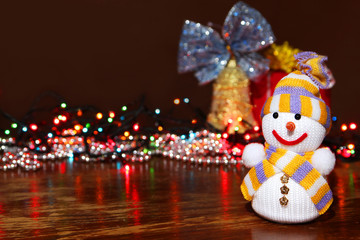 Snowman on the background of Christmas decorations