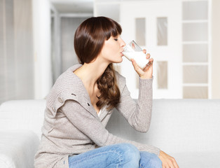 Young woman drinking glass of milk
