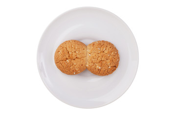 Two fused-glass cookies on a white saucer