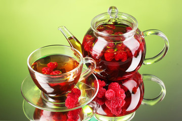 Black fruit raspberry tea in glass teapot and cup