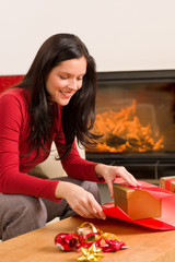 Christmas wrap present happy woman home fireplace