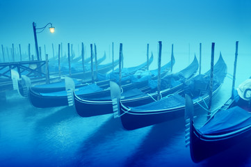 Raw of gondolas in thick fog at early morning;