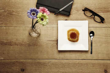 creme caramel over a wood table
