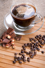Cup of coffee, chocolate with nuts and coffee beans