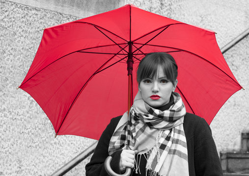 Beautiful woman with red umbrella and red lipstick