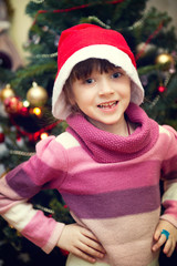 Portrait of little girl in front of Christmas tree