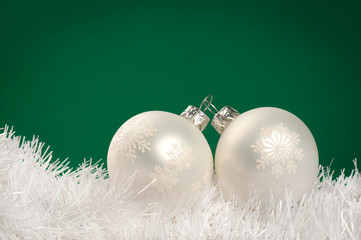 White Christmas baubles on dark green background