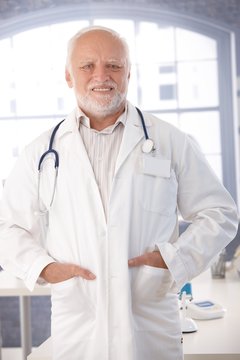 Mature doctor smiling in lab coat