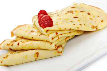 Crepe on a plate with a raspberry