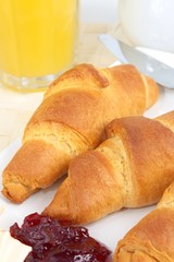 Croissants with butter, jam and orange juice