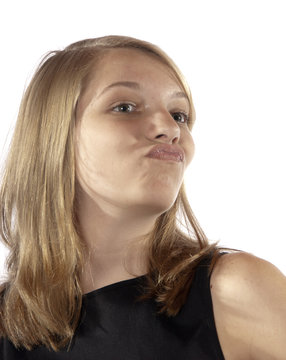 Young teenage girl making facial expressions puckering