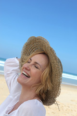 Woman laughing on the beach