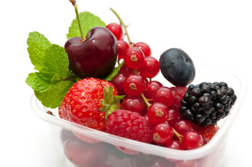 berries in a plastic box on a white background