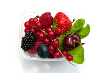 berries in a plastic box on a white background