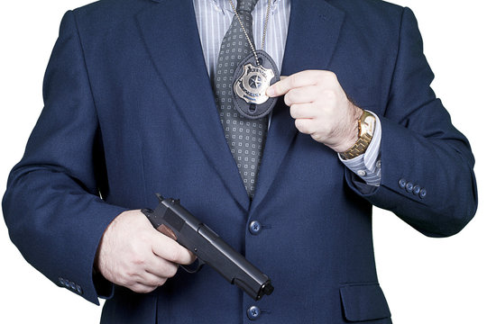 Police office with badhe and gun.