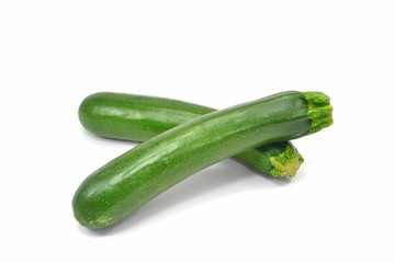 Two whole courgettes on a white background