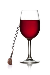 Glass of red wine and corkscrew on a white background