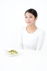 attractive asian woman eating salad