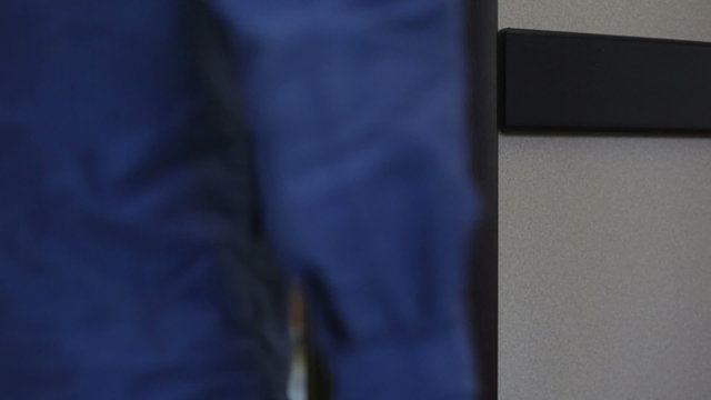 Travaller opens hotel door with a card key, steps in.