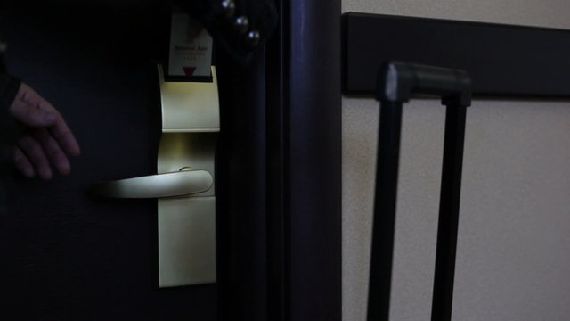 Woman opens a hotel door with a card key