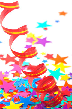 Multicoloured Confetti Stars And Red Streamer