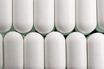 background of white pills closeup
