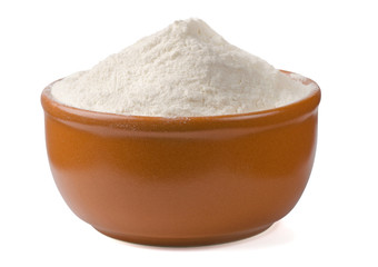 Bowl of fresh wheat flour isolated on white