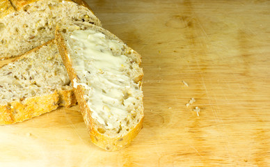 sliced whole grain bread with butter